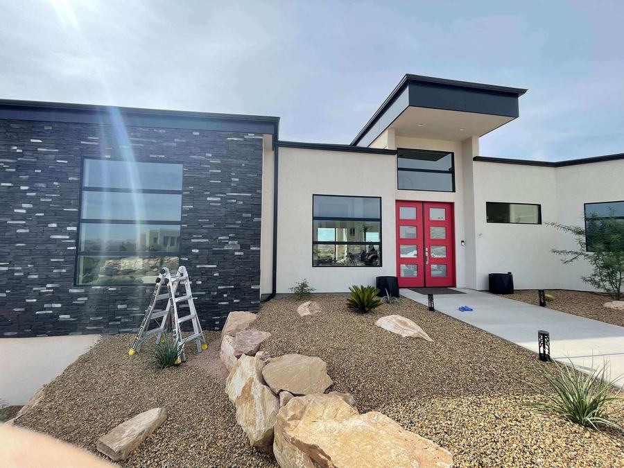 Ladder set up at a modern desert home for a window clean
